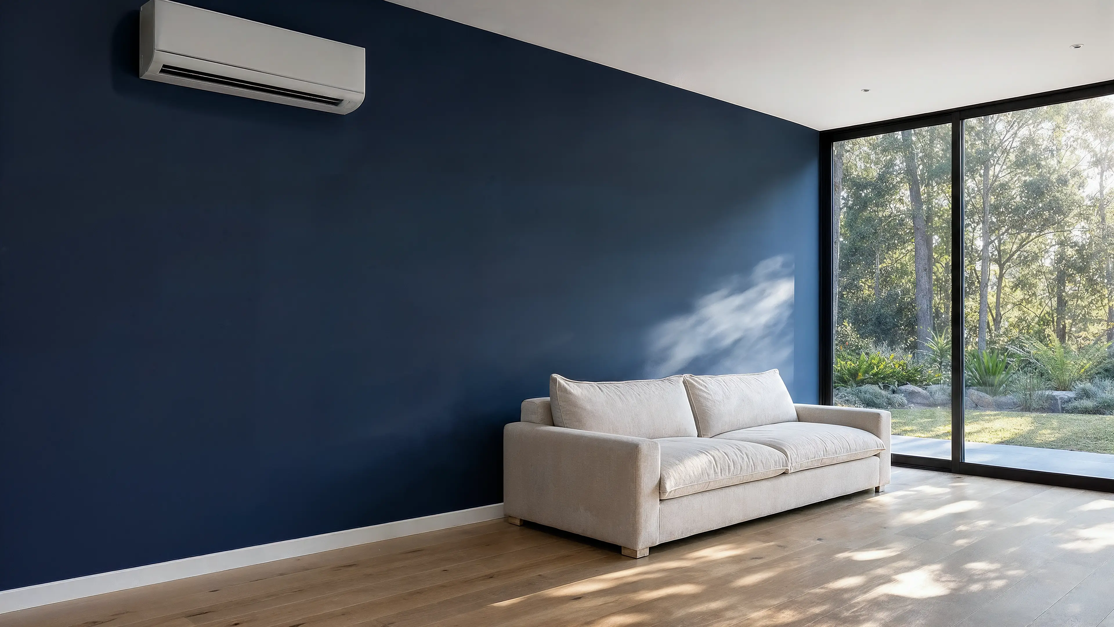 Wall-hung split system air conditioning on a navy feature wall in a modern Sydney living room